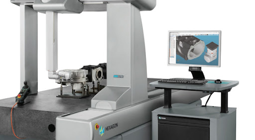 Hexagon CMM machine set up within inspection room, running an inspection program and displaying outputs